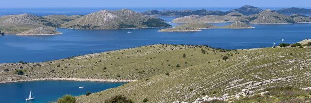 Einsame Ankerbucht inmitten des Inselmeeres vor Mitteldalmatien, Kornaten, Kroatien. Im Bild unten die Amoroso in der Vorbereitung, den Ankerplatz zu verlassen
